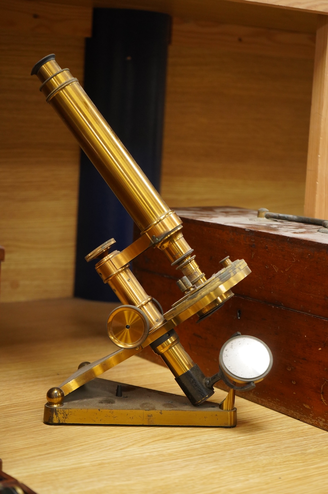 A late 19th century brass compound monocular microscope, by R and J. Beck, mahogany cased, with two objectives, 2 eyepieces and miscellaneous slides, the case dimensions; 40.5 x 15.5x 18cm, together with a small early 19